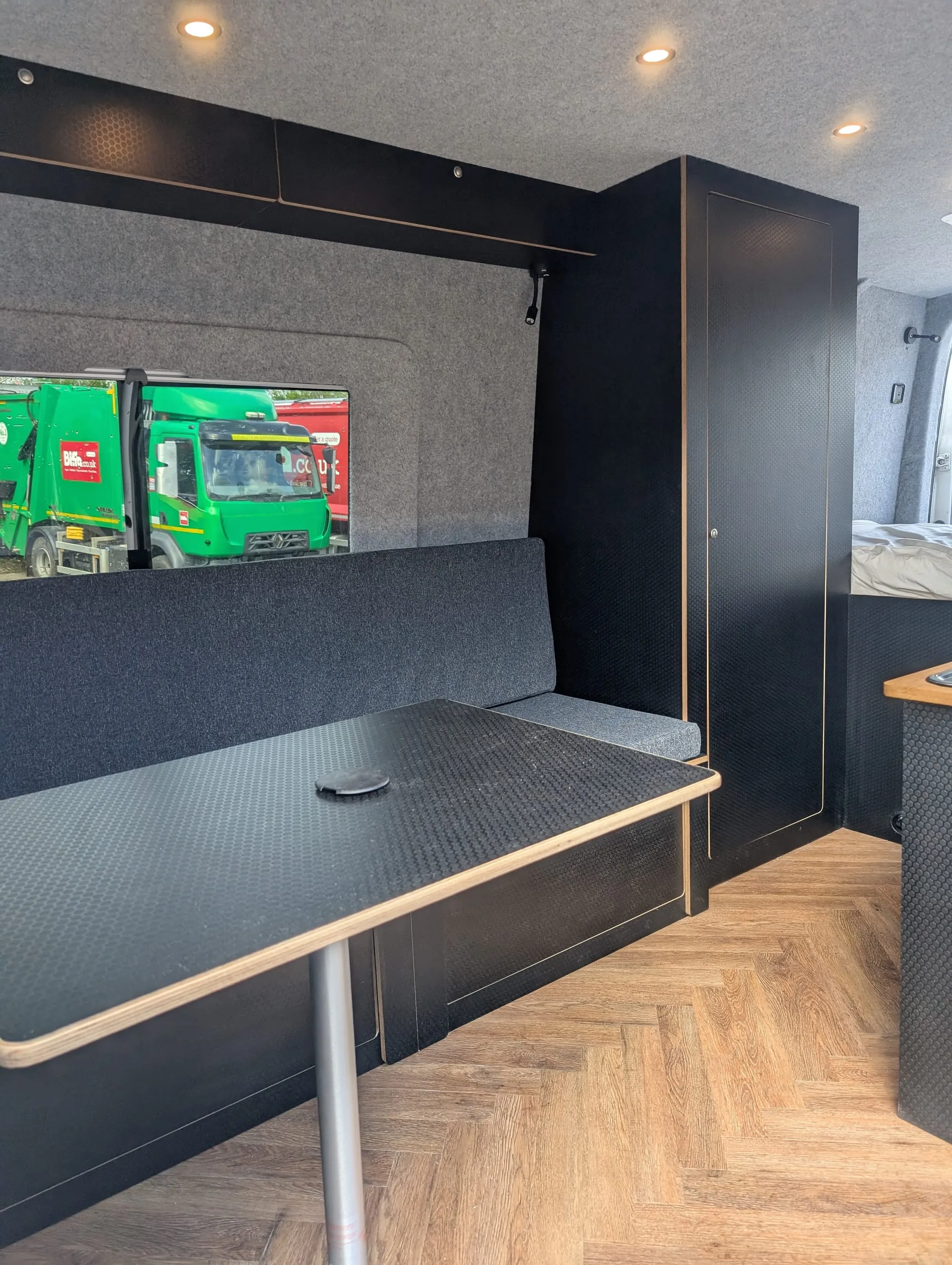 Finished campervan interior with bench seat and table