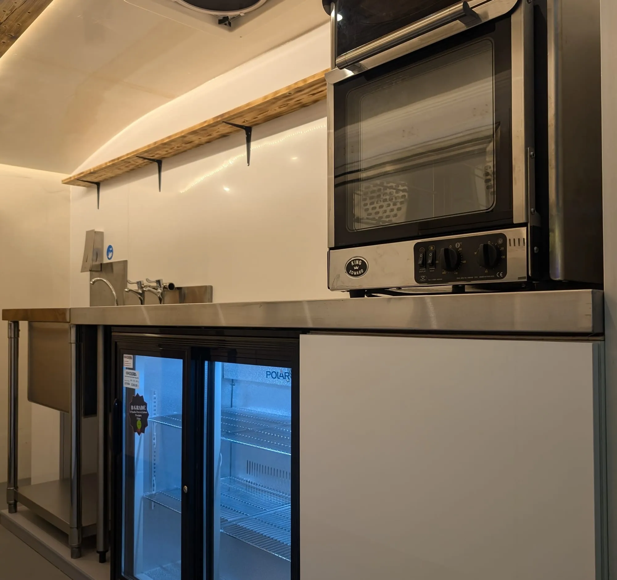 Mobile catering van interior with oven and commercial refrigeration