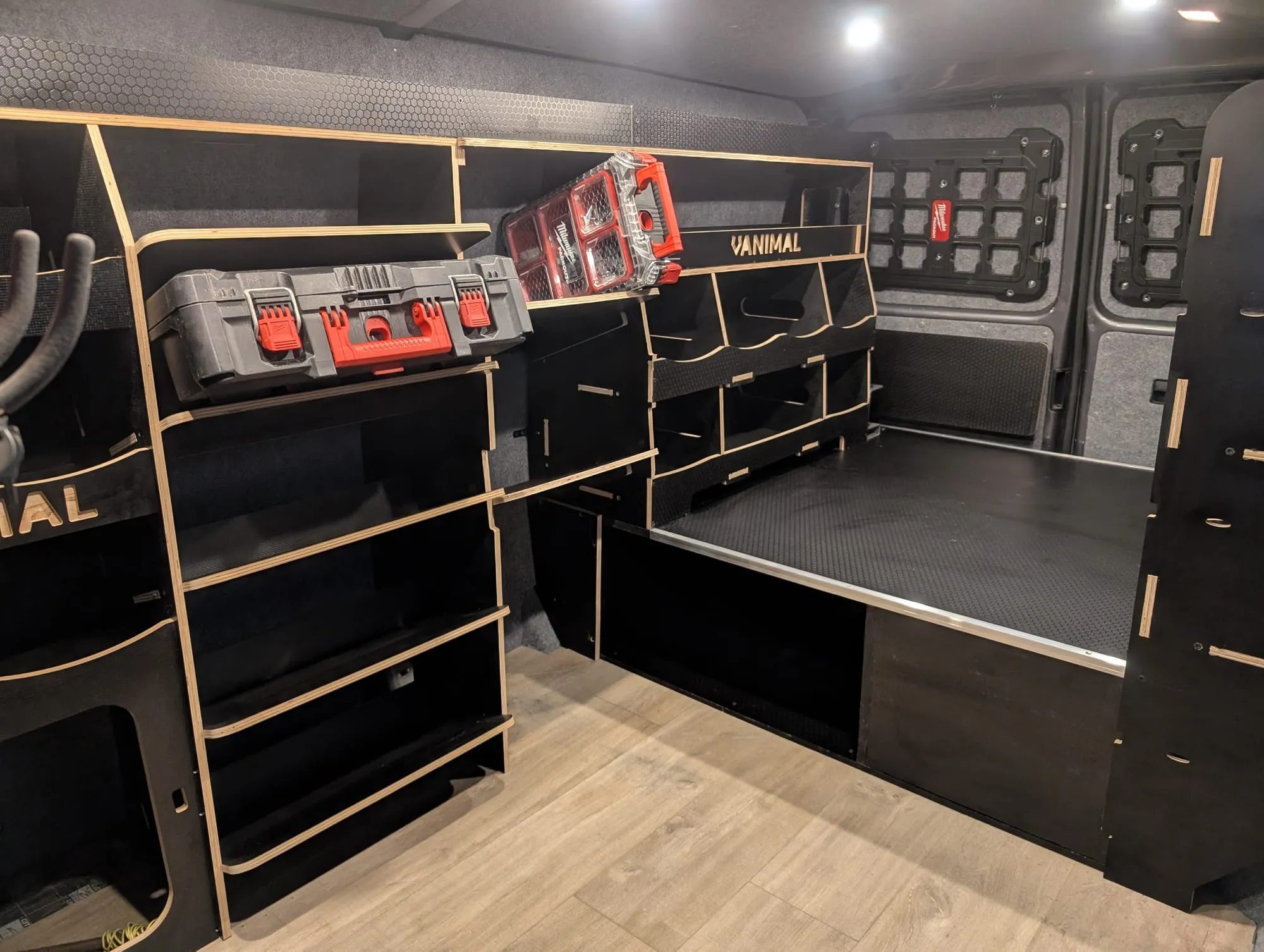 Custom black van racking with storage boxes